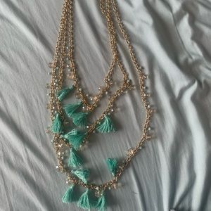 multiple layered gold chain and tassel necklace